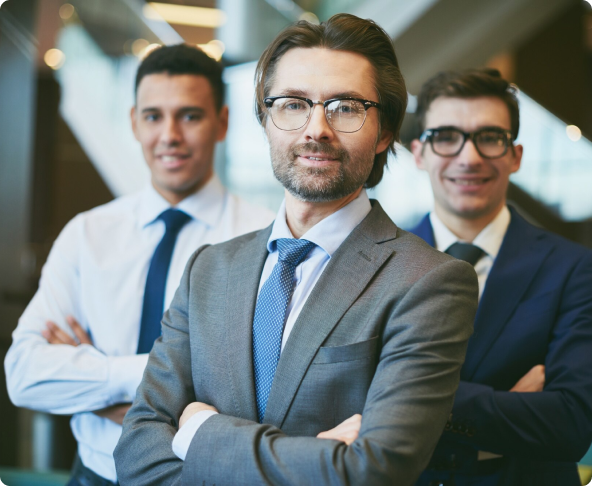 Business professionals in suits standing with arms crossed